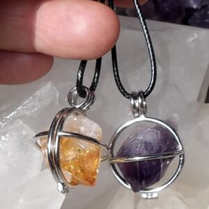 Raw crystals in hinged cage pendants