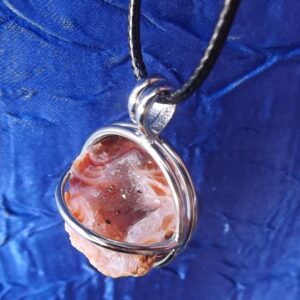 Raw crystals in hinged cage pendants